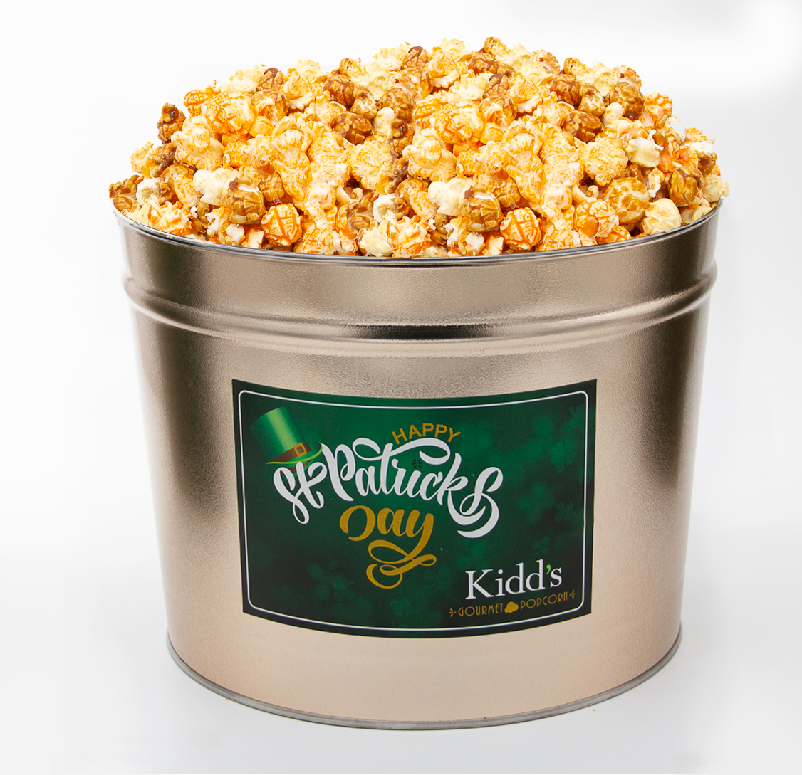 famous three flavor mix - caramel, white cheddar, cheese served in 2 gallon st. patrick's day holiday gift tin.