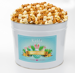 Load image into Gallery viewer, Buy Medium Easter Basket Tin filled with Caramel And White Cheddar Popcorn.
