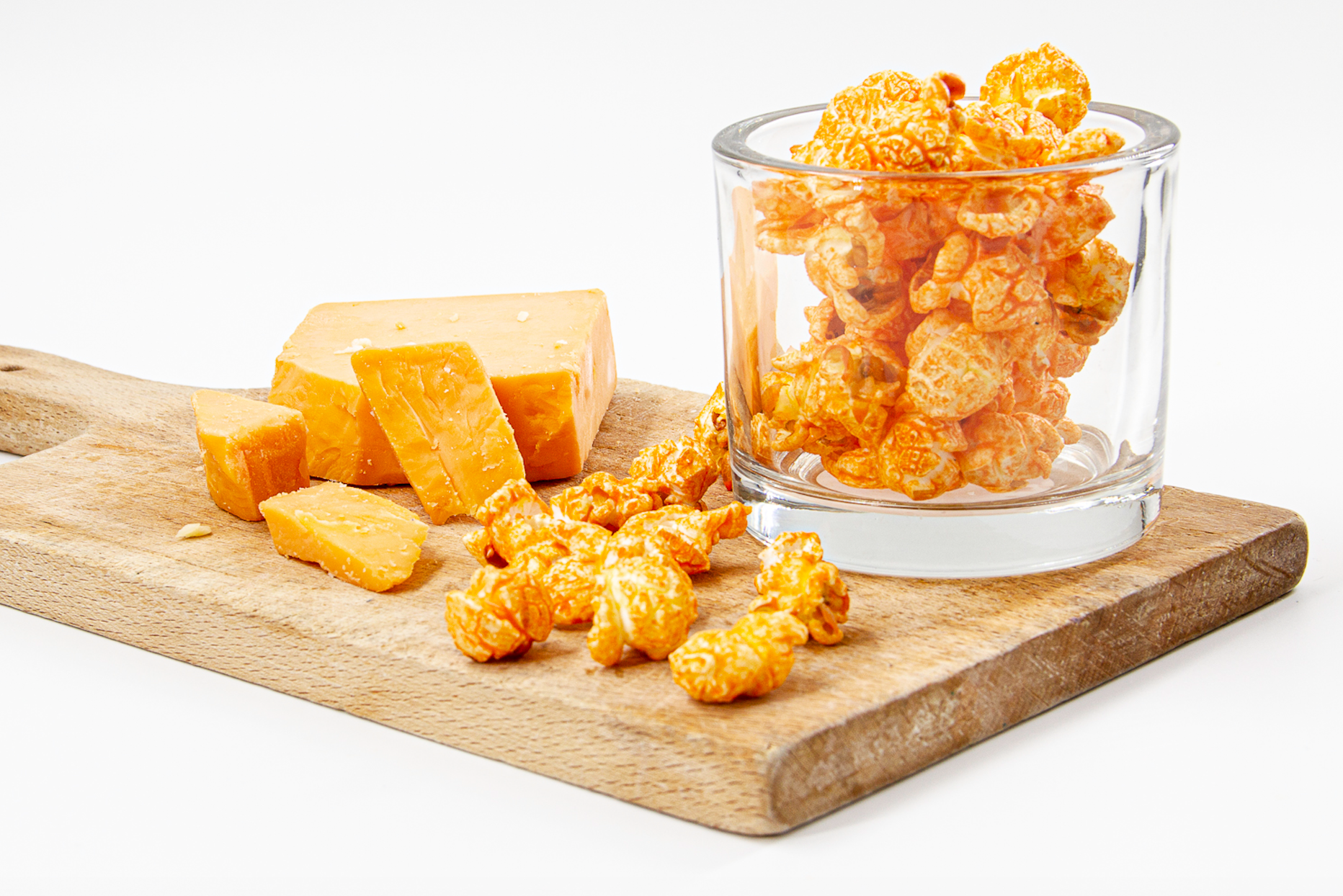 Cheese Popcorn displayed on wood cutting board with real cheese bites