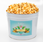 Load image into Gallery viewer, All three of our best flavors Cheddar, White Cheddar and Sweet, buttery caramel corn mixed together in medium Easter Tin for events and parties.
