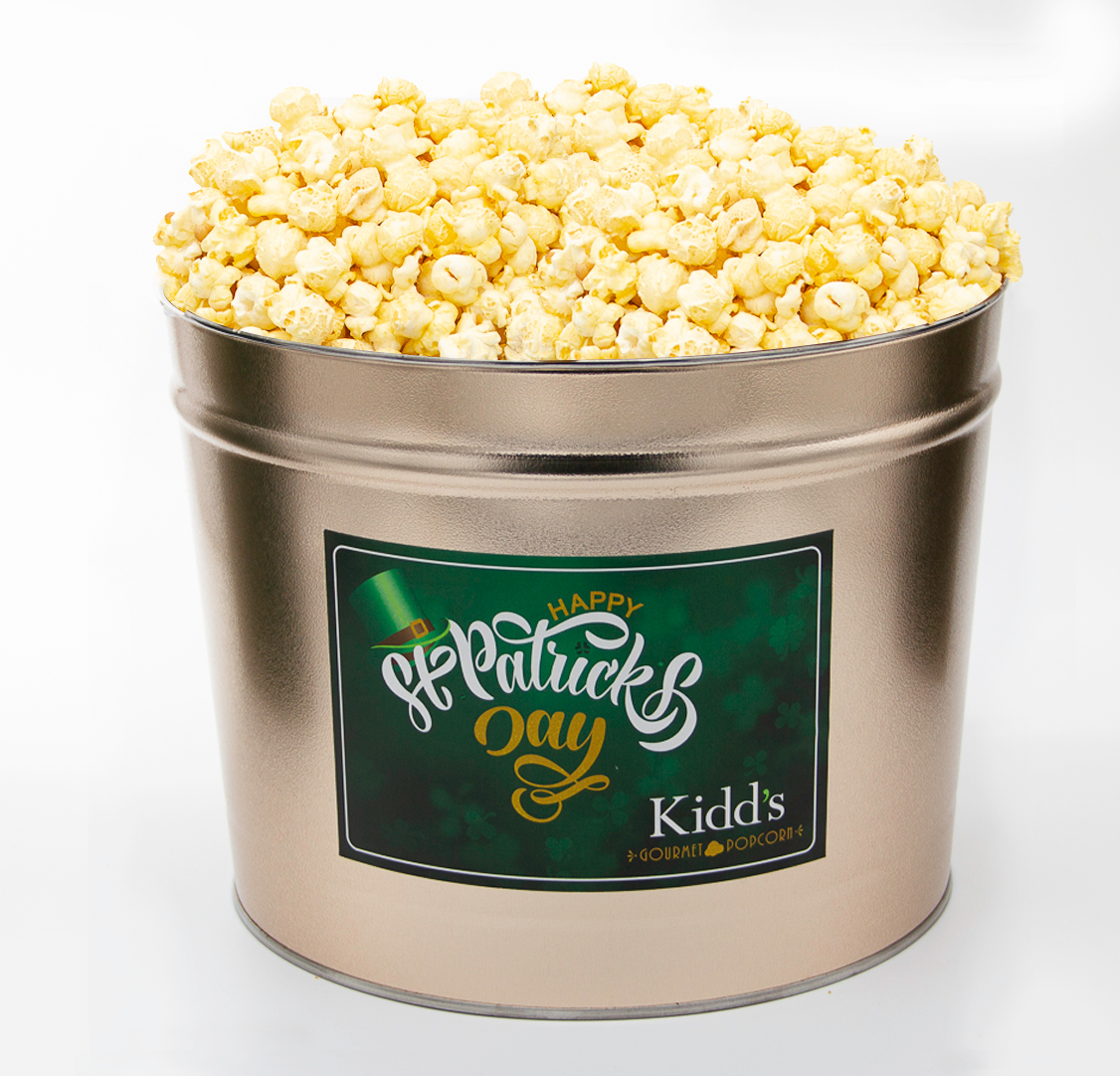 Indulgent white cheddar gourmet popcorn in 2 gallon St. Patrick's Day Popcorn tin.