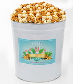 Load image into Gallery viewer, The best caramel popcorn and white cheddar filled in a large deliverable easter basket tin. Perfect for large Easter gatherings and egg hunts
